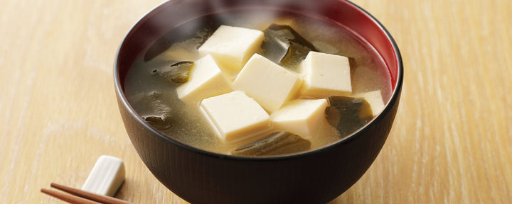 Steamy tofu and seaweed miso soup served in a traditional Japanese lacquer soup bowl