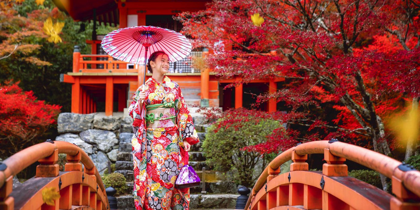 Japanese girl in kimono traditional dress walk in red bridge in Daigoji temple in autumn time, Kyoto, Japan