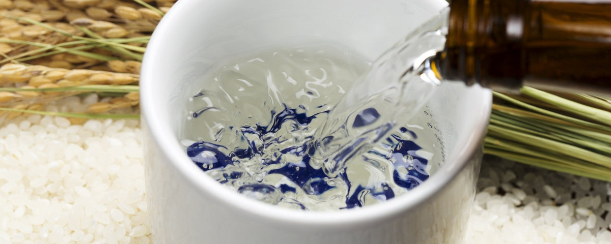 Sake rice wine poured into a sake cup