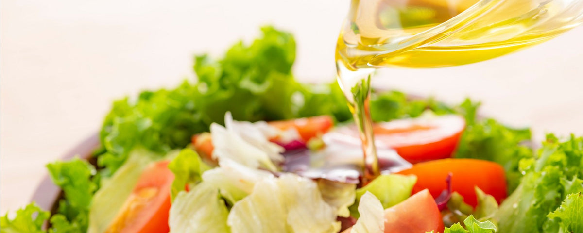 Japanese dressing being drizzled over leaves