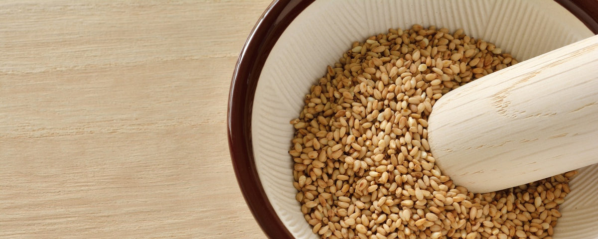 Traditional Japanese ceramic mortar filled with white sesame seeds